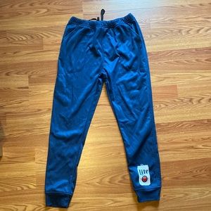Miller Lite, Dark blue track pants.